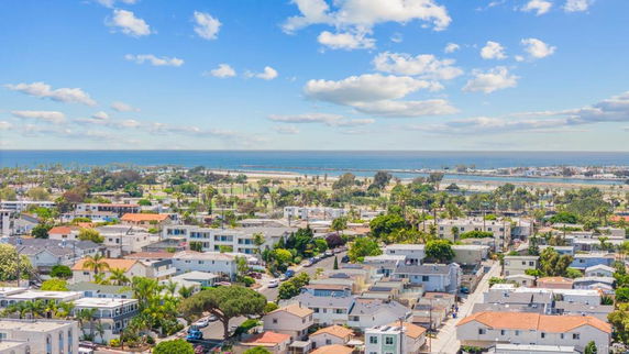 Panoramic view of a coastal residential area with the ocean in the background.