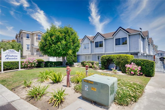 Front view of a residential building with multiple units and pitched roofs.