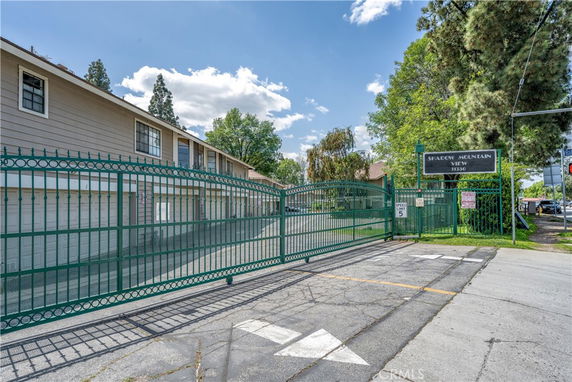 Front view of a two-story building with a gated entrance.