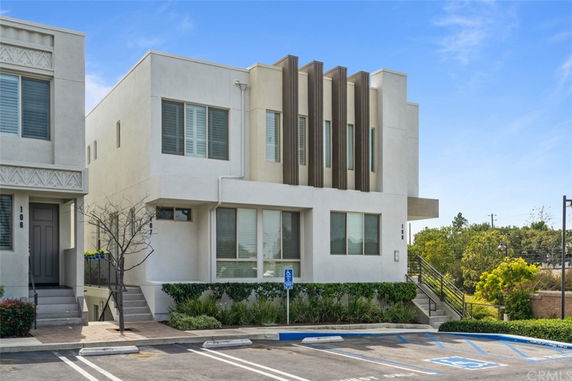 Front view of a modern two-story corner building with large windows and architectural detailing.