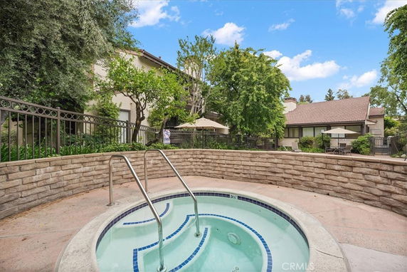 Outdoor area with a small circular swimming pool and surrounding seating.