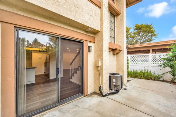 Exterior view of a house with sliding glass door and patio area.
