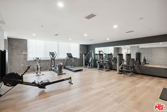 Indoor gym area with exercise equipment and mirrors.