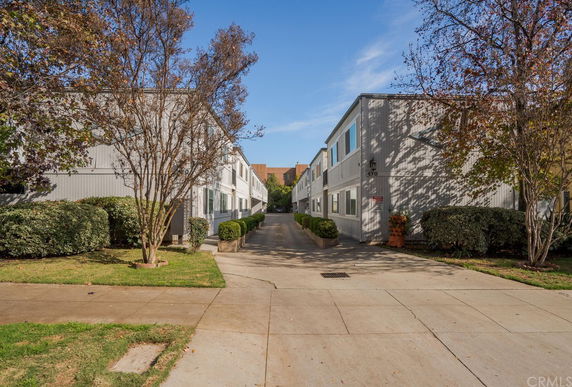 Front view of a two-story building with a central driveway.
