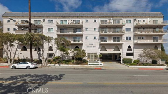 Front view of a multi-story residential building with balconies.