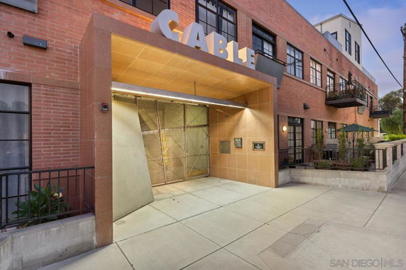 Front view of a multi-story building with a covered entrance.