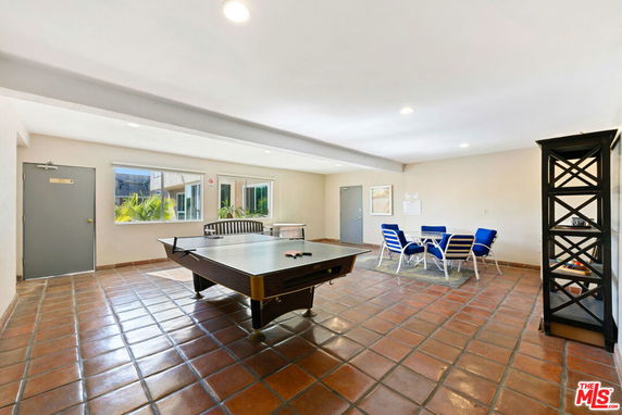 Indoor recreation area with a ping pong table and seating space.