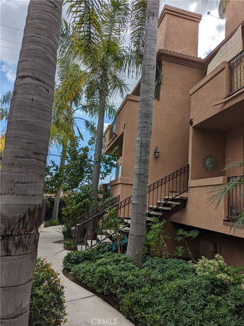 View of a multi-story building with external staircases and balconies.
