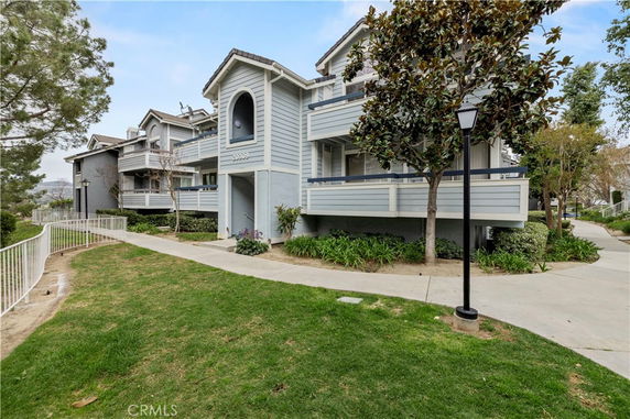 Front view of a multi-story residential building with balconies.