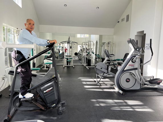 Gym area with various exercise machines and equipment.