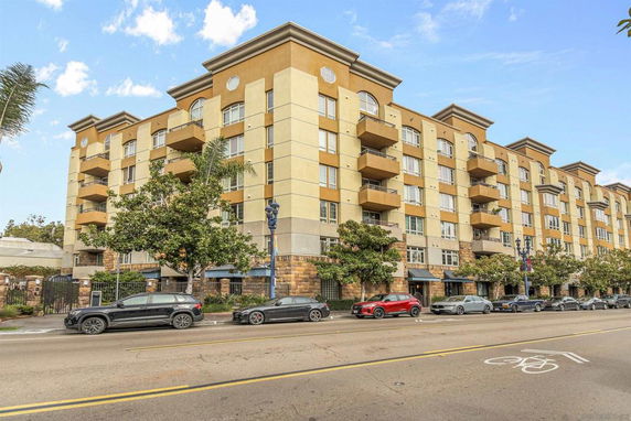 Front view of a multi-story apartment building with balconies.