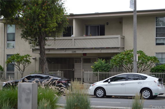 Front view of a two-story apartment building with a balcony.