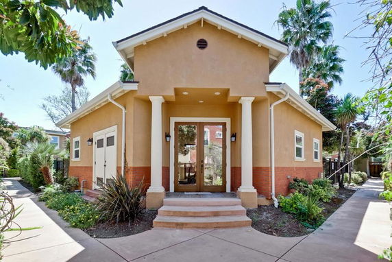 Front view of a single-story house with a wide entrance and columns.