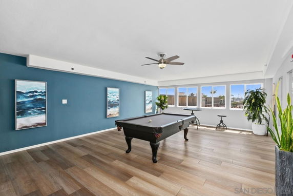 Room with a pool table and blue accent wall