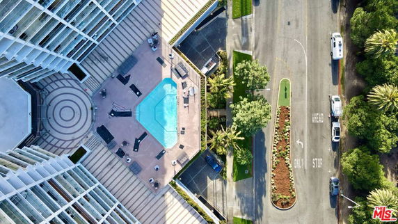 Aerial view of a swimming pool area surrounded by a building.
