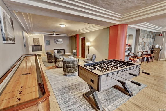 Indoor recreation area with games like foosball and shuffleboard, and seating arrangements.