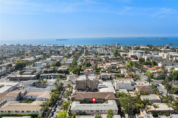 Panoramic view of a coastal city with buildings and ocean in the background.