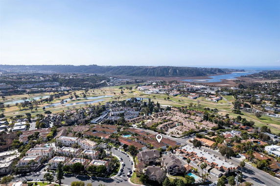 Panoramic view of a residential area with surrounding landscape and water bodies.