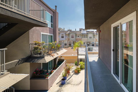 View of multistory residential buildings with balconies and railings.