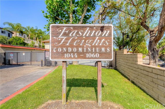 Front view of Fashion Heights Condominiums with a sign at the entrance.