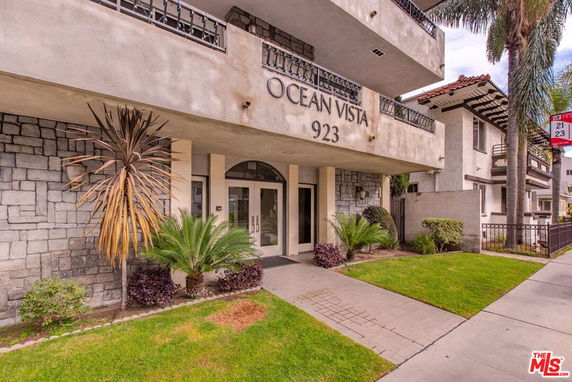Front view of a multi-story building with balconies and a main entrance labeled 'Ocean Vista 923'.