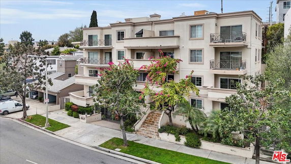 Front view of a multi-story residential building with balconies.