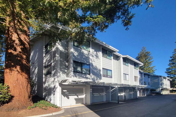 Front view of a multi-story residential building with garages.