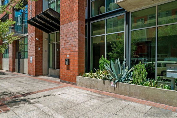 Front view of a modern building with brick exterior and large glass windows.