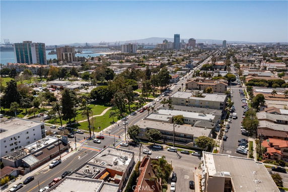 Panoramic view of an urban area with buildings and streets, overlooking the coastline.