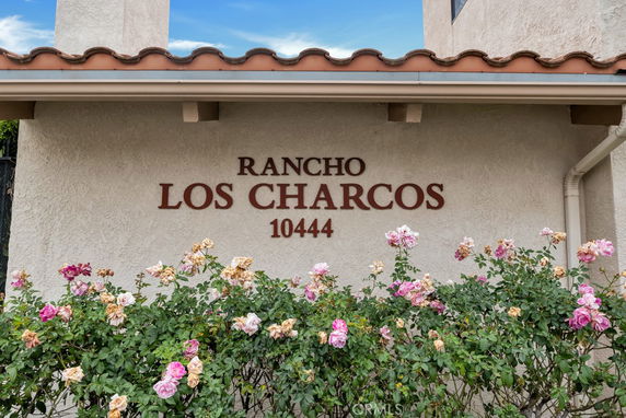 Front view of a building exterior with the name 'RANCHO LOS CHARCOS' and the number '10444' on the wall.