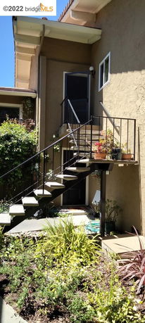 External staircase leading to an upper level entry of a building.