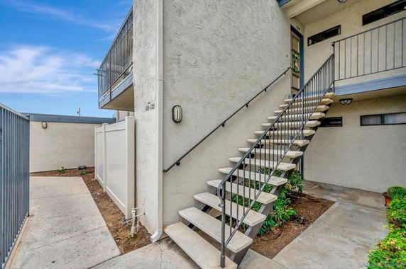 Exterior view of a building staircase leading to the upper floor.