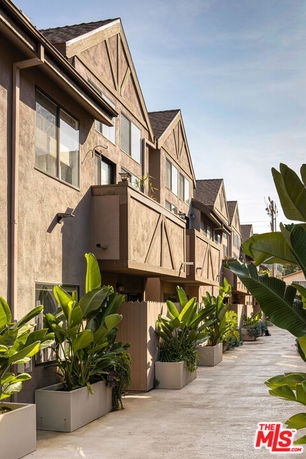 Front view of a multi-story residential building with balconies.