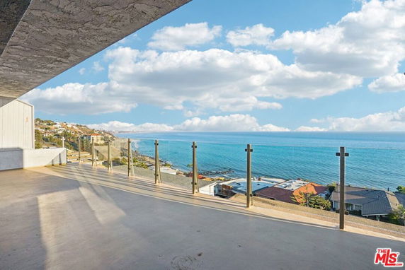 Panoramic view from a balcony overlooking the ocean and coastline.