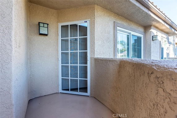 Entrance area of a house with glass door and windows.