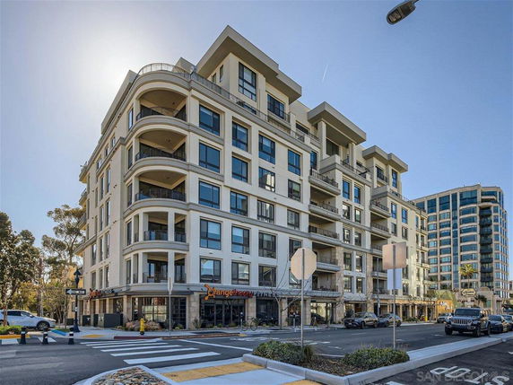 Front view of a multi-story residential and commercial building.
