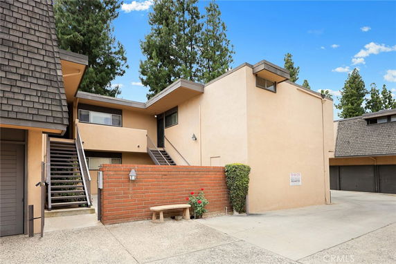 Front view of a two-story building with external stairs.