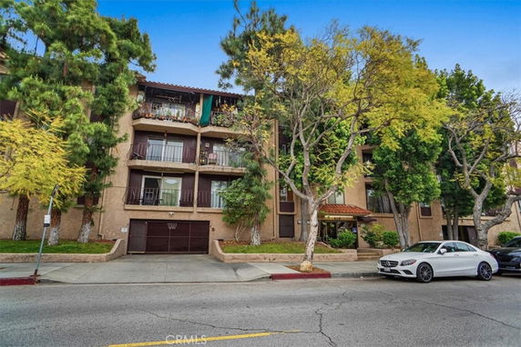 Front view of a multi-story residential building with balconies.
