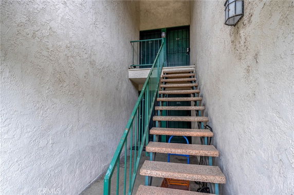 Exterior staircase leading to the front door of a building.