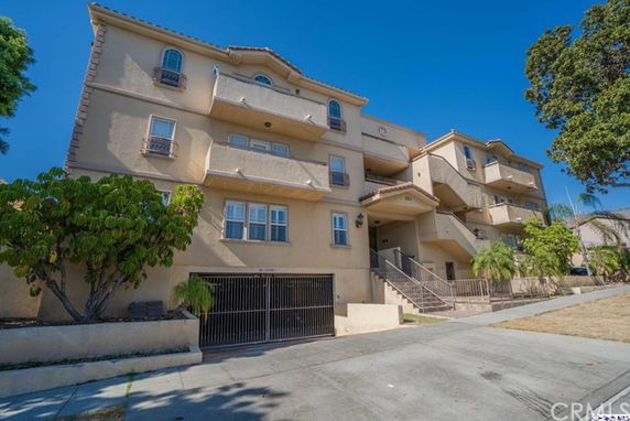 Front view of a multi-story residential building with balconies.