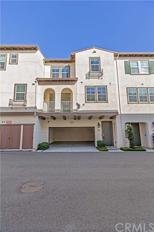 Front view of a multi-story townhouse with garage.