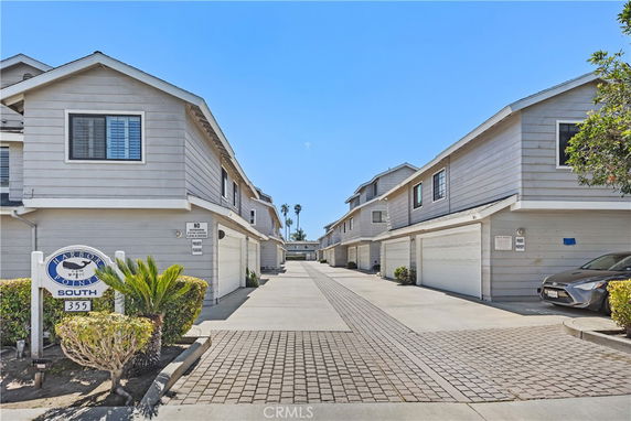 Front view of a row of two-story townhouses with attached garages.