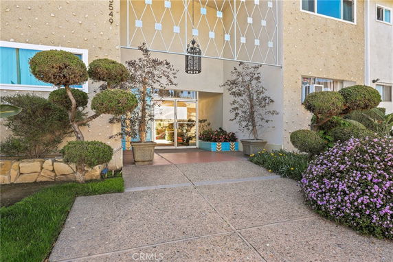 Front view of a building with a landscaped entrance.