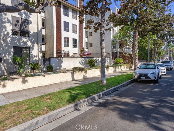 Front view of a multi-story residential building with balconies.