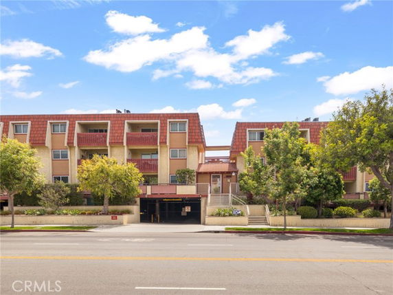 Front view of a multi-story residential building with balconies.