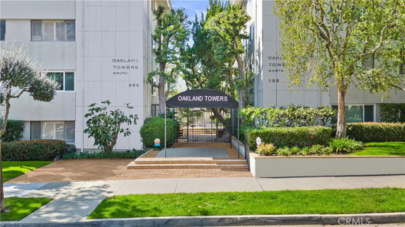 Front view of a multi-story building with an entrance canopy labeled 'Oakland Towers.'
