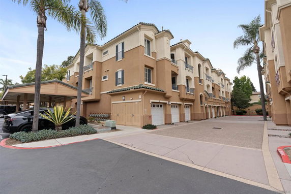 Front view of a multi-story residential building with garages.