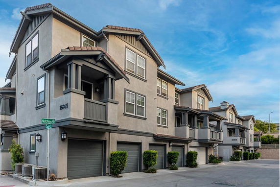 Front view of a multi-story residential building with garages.