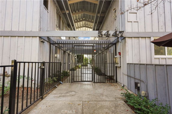 Front view of a building entrance with a gated entry.