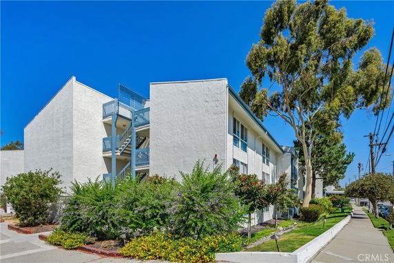 Front view of a multi-story building with exterior staircases.
